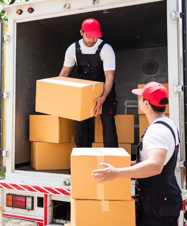 Workers loading boxes into delivery truck.